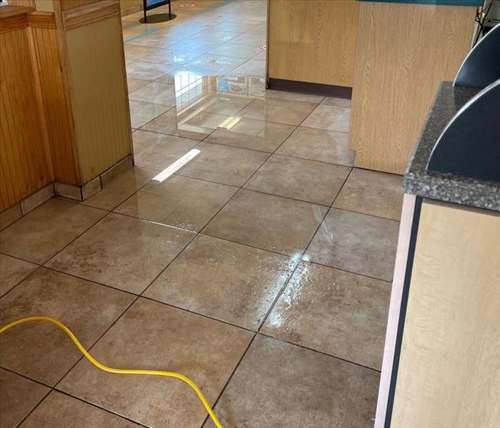 A fast food lobby has water on their floor.