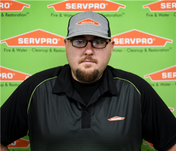 Image of male sitting in front of SERVPRO backdrop