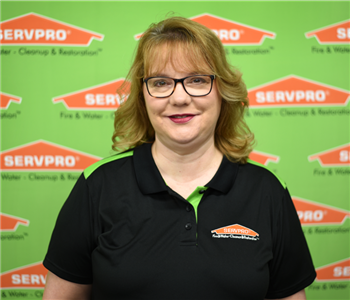 Image of female sitting in front of SERVPRO backdrop
