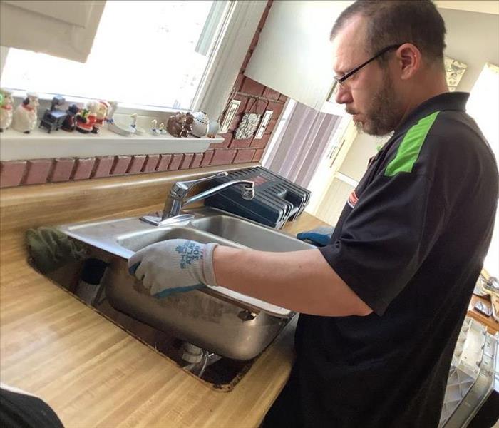 SERVPRO team member is removing a sink.