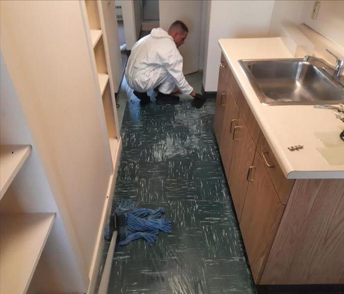SERVPRO team member cleaning the floor.