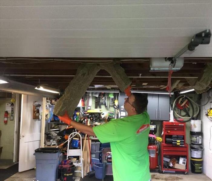 SERVPRO team member is working on a garage ceiling.