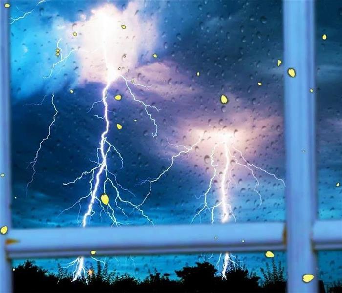 image of rainfall and lightning through a window
