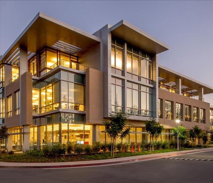 photo of large commercial building with all interior lights on