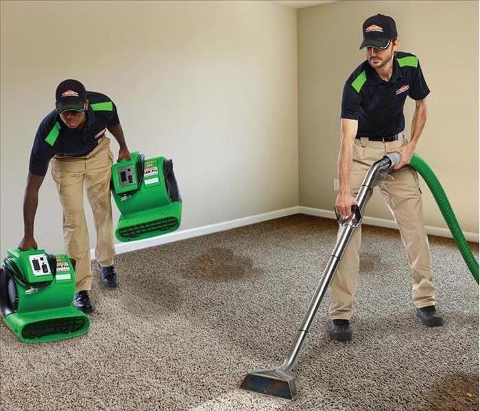 image of SERVPRO technician using hot water extractor to clean a carpet fully