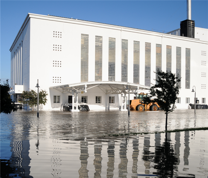 Flooded water in front of commercial building.