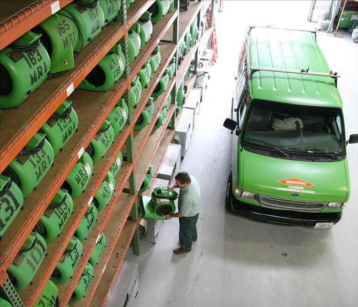 image of SERVPRO workers removing drying equipment from a vehicle that are to be placed for water damage